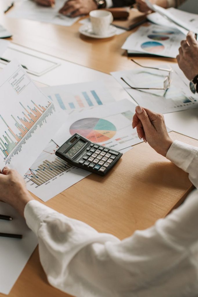 Business team analyzing financial data and graphs during a meeting to strategize growth.